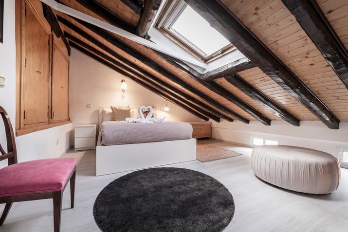 bedroom-in-an-attic-room-with-sloping-ceilings-with-vintage-wood