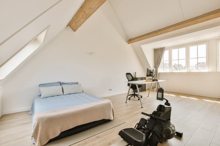 a-bedroom-with-a-bed-a-desk-and-a-chair